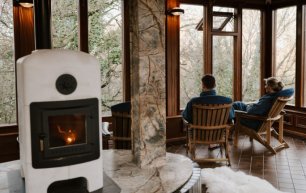 Male and female sitting facing out to frosted trees in a spa room